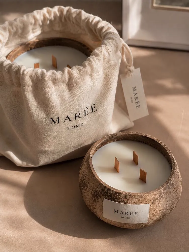 Two coconut shell candles with hand-rolled matches in a linen pouch and a gift box